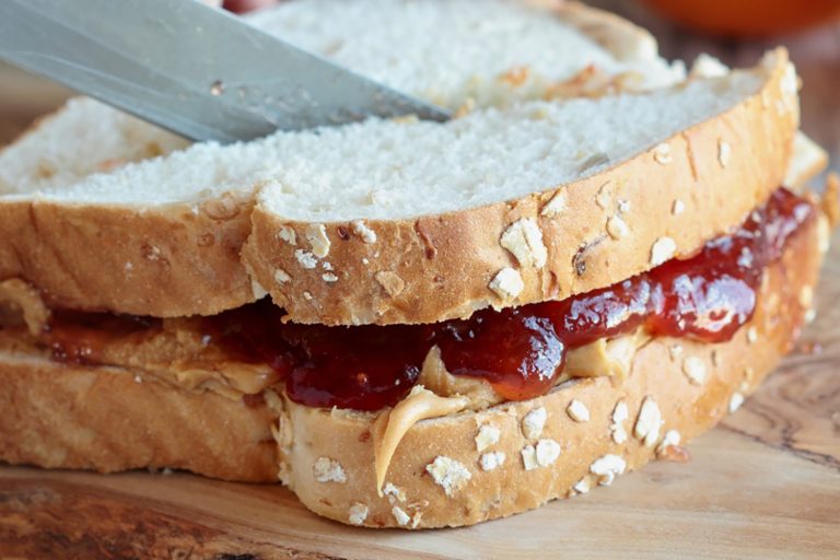 Cutting a peanut butter and jelly sandwich